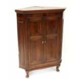 A George III mahogany flat-fronted cross banded and boxwood strung two-door corner cupboard with