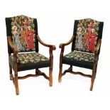 A pair of William & Mary style walnut open arm chairs with scroll arms,
