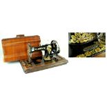 A 19th century Jones sewing machine in wood carry case, number 451234.