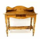 A Victorian pine single-drawer side table with gallery top on turned and block legs with undershelf,