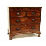 A George III mahogany chest of two short and three long drawers with brass drop handles,
