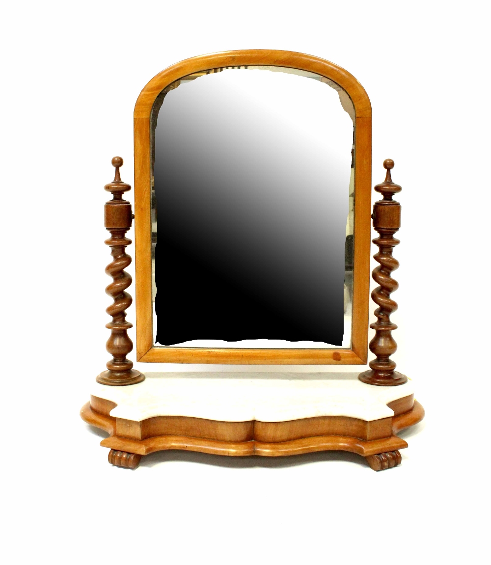 A Victorian mahogany swivel toilet mirror with spiral twist side supports on shaped marble base