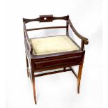A mahogany-framed piano box seat stool with low back and open arms above upholstered seat with