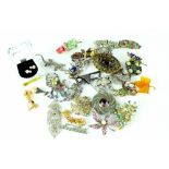 A mixed collection of various costume brooches, pins,