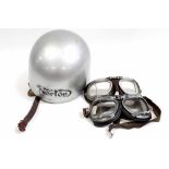 A vintage Norton motorcycle helmet in silver with company logo to the front,