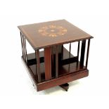 An Edwardian inlaid mahogany revolving bookcase with inlaid top, on quadripartite base,