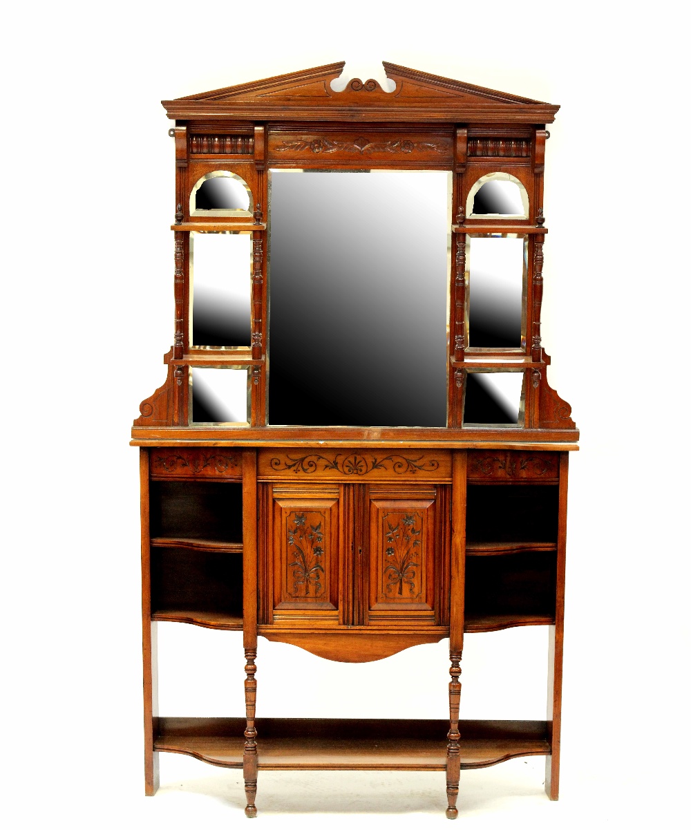 An Edwardian mahogany break-front cabinet with matched mirrored top, carved foliate decoration,