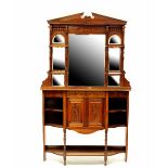 An Edwardian mahogany break-front cabinet with matched mirrored top, carved foliate decoration,