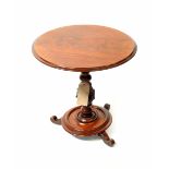 A Victorian circular topped occasional table with turned and carved column and an Edwardian inlaid