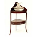 An Edwardian mahogany corner wash stand with pierced top and undershelf,
