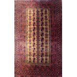 A small red ground Turkish woollen carpet with all-over geometric design, approx 157 x 92cm.