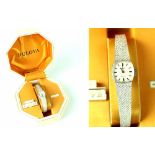 A ladies' vintage 9ct white gold Bulova watch, the square dial set with baton time increments,