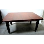 A Victorian mahogany wind-out dining table with two additional leaves,