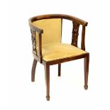 An Edwardian mahogany tub chair supported by shaped pierced spindles, upholstered seat,