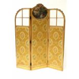 A 19th century three-fold gilt wood screen, the central panel with hand coloured oval print,