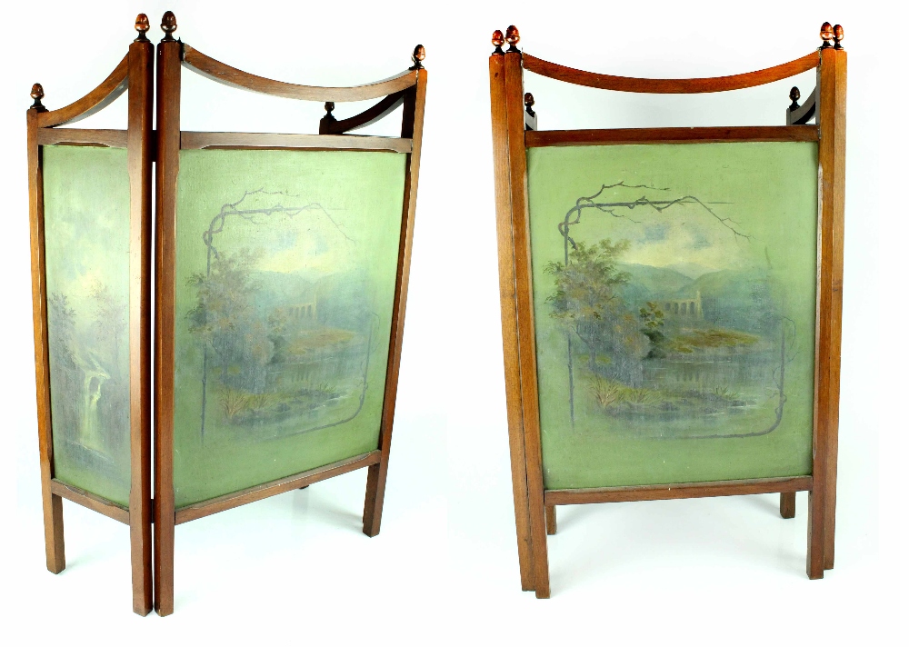 An Edwardian mahogany three-fold fire screen, each panel with hand painted woodland scene,