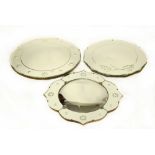 Three retro wall mirrors comprising two circular examples and a further shaped example,