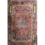 A Turkish blue ground woollen rug with central geometric lozenge surrounded by stepped border,