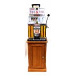 The 'Governor' by Jennings 2p slot machine with Native American finial to front, on later stand,