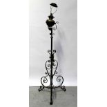 A Victorian brass oil lamp converted to electricity, raised on adjustable cast iron base,
