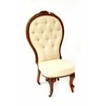 A Victorian walnut spoon back bedroom chair with carved decoration, on squat cabriole legs,