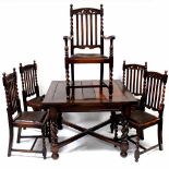 A 1930s dining suite comprising extending dining table raised on column supports to cross stretcher,