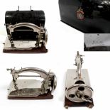 A Salters 'Ideal' portable chain stitch sewing machine, hand cranked in black tin carry case,
