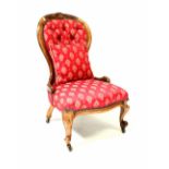A Victorian walnut spoon back chair with carved decoration, with serpentine front on cabriole legs,