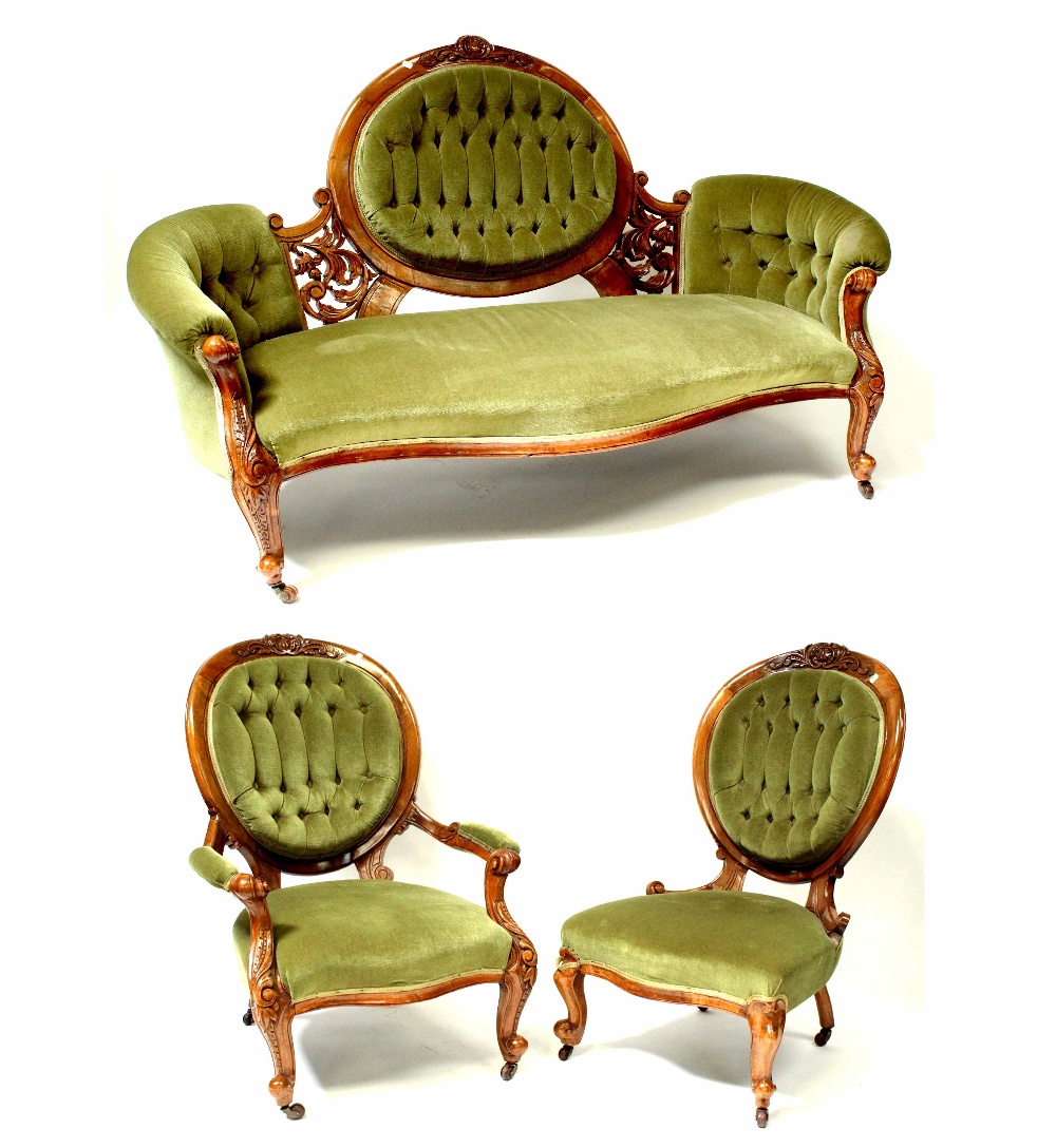 A Victorian walnut three-piece suite comprising three-seater settee,