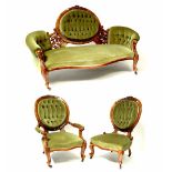 A Victorian walnut three-piece suite comprising three-seater settee,