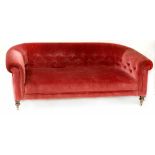 A Chesterfield-style settee upholstered in wine coloured button-back Draylon,