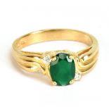 A 9ct yellow gold dress ring with oval green coloured central stone, size P, approx 3.9g.