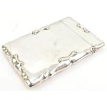 CHARLES S GREEN & CO LTD; an Edward VII hallmarked silver card case with cast scrolling edge,