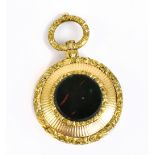A 19th century yellow metal vinaigrette of circular form, with cast loop rotating handle and