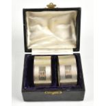 D BROS; a pair of George VI hallmarked silver napkin rings, with engine turned detail surrounding