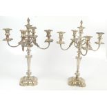 A pair of Elizabeth II hallmarked silver four branch candelabra, each raised central section above