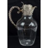 W & G SISSONS; a late Victorian hallmarked silver mounted and clear glass claret jug with hinged