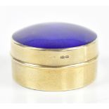 GS; a George V imported hallmarked silver gilt pill box and cover with blue guilloche, import