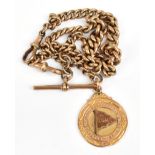 A 9ct yellow gold fob chain with double spring clips and T-bar with fob inscribed 'Bradford Gipsy