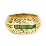 An 18ct yellow gold emerald and diamond ring, the central panel of baguette cut emeralds flanked