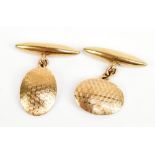 A pair of 9ct yellow gold cufflinks with engraved oval platforms and torpedo backs, each platform