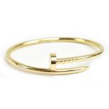 CARTIER; a 'Juste Un Clou' 18ct yellow gold bracelet in the form of a coiled nail with hidden