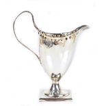 A George III hallmarked silver helmet shaped cream jug, with simple loop handle and stepped square