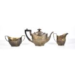 A matched hallmarked silver three piece tea service, each with gadrooned lower body, the teapot with