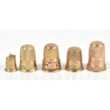 Two hallmarked 9ct yellow gold thimbles and a 9ct yellow gold thimble charm, combined approx 10.