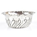 CHARLES EDWARDS; a late Victorian hallmarked silver and punch decorated small bowl with flared