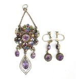 An unusual white metal enamel decorated and amethyst set pendant with both front and reverse