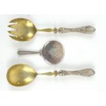 A pair of German salad servers with 800 grade silver handles, with cast floral detail and engraved