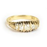 A 18ct yellow gold and five stone graduated diamond ring, the central stone weighing approx 0.10cts,