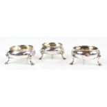 A pair of George II hallmarked silver open circular salts raised on three stepped hoof supports,